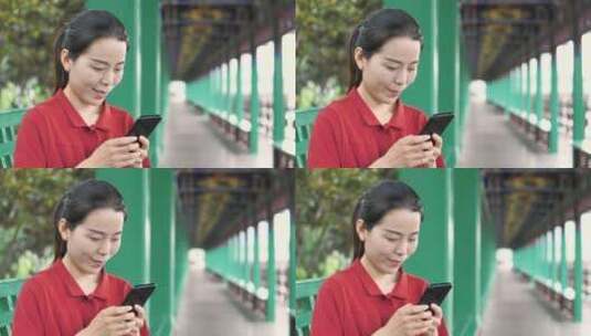 中国女性路边玩手机拍照通讯聊天高清在线视频素材下载