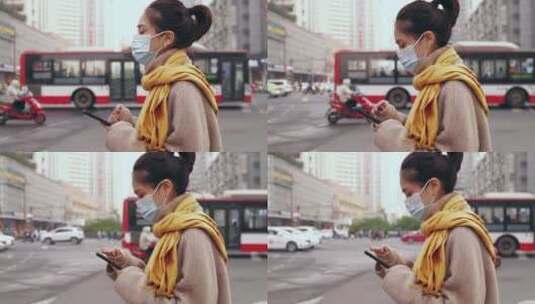 都市女青年戴着口罩街头看手机等车高清在线视频素材下载