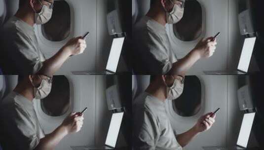 疫情期间男子在飞机上使用手机和笔记本电脑高清在线视频素材下载