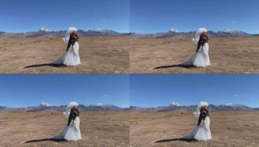 高原枯黄草原雪山拍美女写真婚纱高清在线视频素材下载