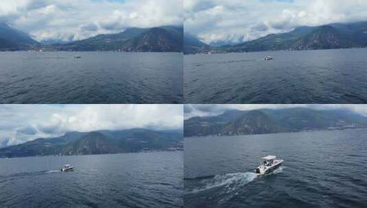 无人机拍摄了意大利科莫湖与阿尔卑斯山水域航行的船只高清在线视频素材下载
