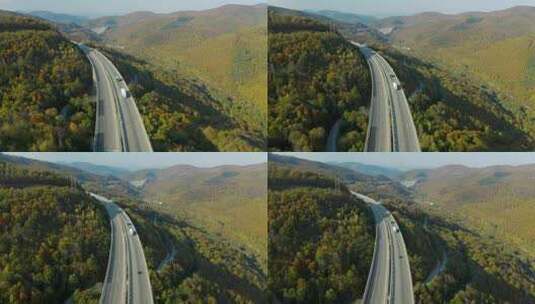 航拍车辆行驶在山间的高速公路上高清在线视频素材下载