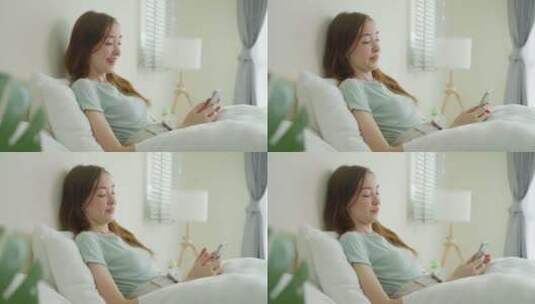 高加索美女在家卧室里用手机聊天。高清在线视频素材下载