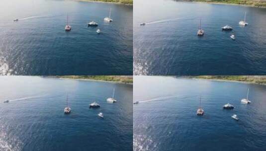 一架双体船在留尼汪岛附近载人和多艘船的无人机镜头。高清在线视频素材下载