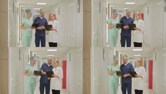 医疗队在医院走廊讨论病人记录高清在线视频素材下载