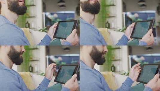 快乐的高加索男子在家中平板电脑上使用智能家居界面的视频高清在线视频素材下载