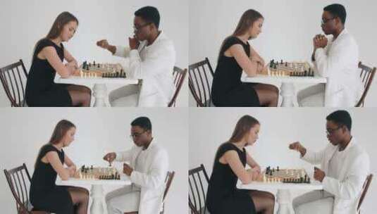 一个美丽的高加索女孩和非裔美国人下棋高清在线视频素材下载