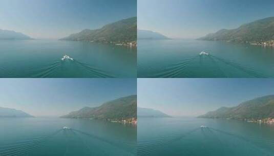 意大利马焦雷湖上一艘船巡航的广角镜头。多莉向后，露出镜头高清在线视频素材下载
