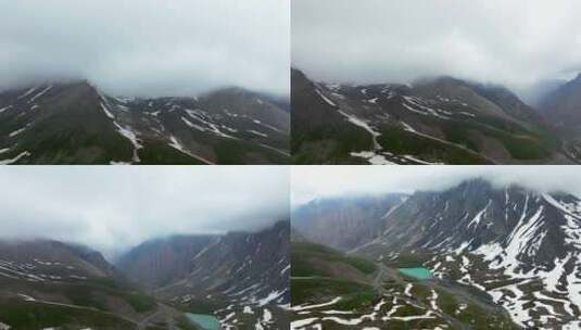 新疆独库公路哈希勒根达坂雪山和小湖泊航拍高清在线视频素材下载