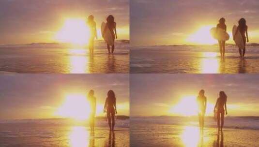 日落时分，两名名女子在沙滩上拿着冲浪板高清在线视频素材下载