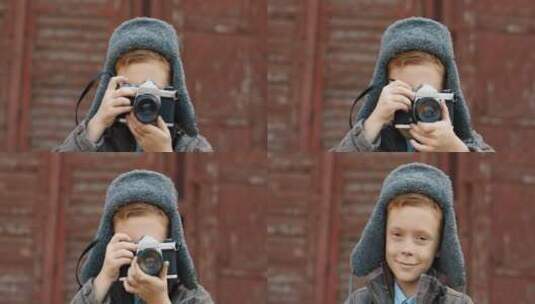 小男孩在户外拿着相机拍摄高清在线视频素材下载