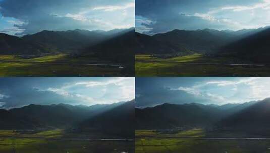 夕阳透过云层打在山脚的金黄稻田上高清在线视频素材下载