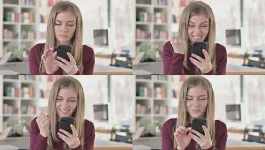 年轻女子在智能手机上庆祝的肖像高清在线视频素材下载