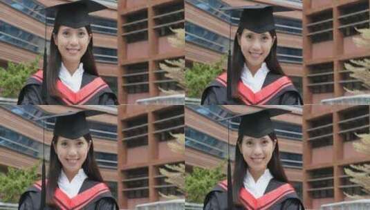 女生穿着毕业礼服站在楼前微笑高清在线视频素材下载