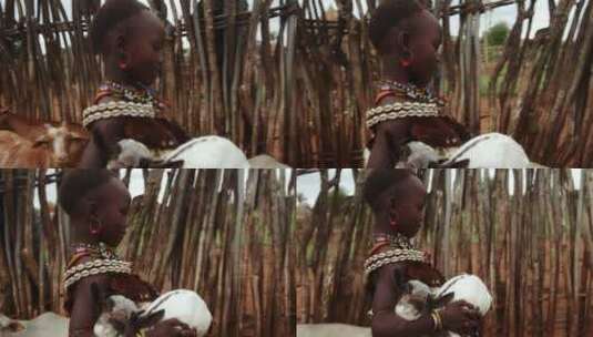 抱小羊的非洲女孩高清在线视频素材下载