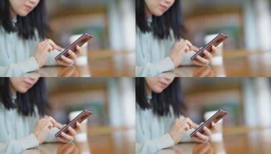 年轻女子在咖啡店使用智能手机通讯高清在线视频素材下载