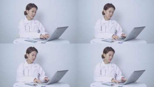 女医生使用笔记本电脑工作高清在线视频素材下载