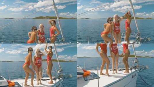 三个穿着红色比基尼的年轻女人在公海上的游艇上诱人地移动高清在线视频素材下载