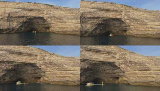 旅游船从法国科西嘉岛的博尼法乔悬崖圣安东尼宽洞穴出来。50fps镜头高清在线视频素材下载