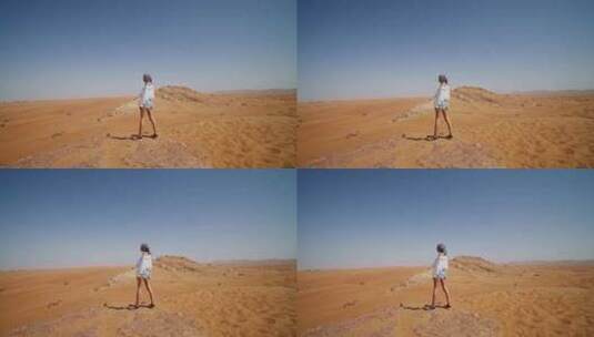 白衣女子站在沙丘边眺望沙漠高清在线视频素材下载