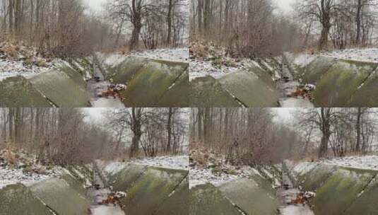 化雪后的公园里涓涓不息的小溪高清在线视频素材下载