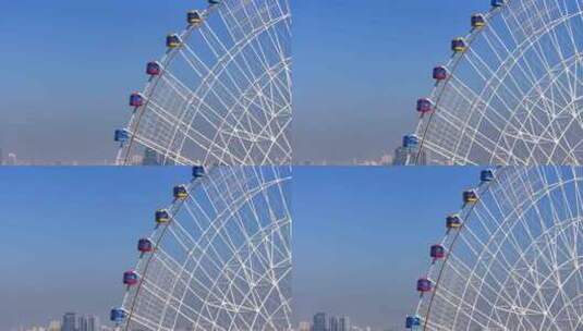 城市蓝天下的摩天轮航拍高清在线视频素材下载