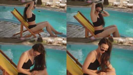 慢动作一个女孩坐在游泳池附近的沙滩椅上，高清在线视频素材下载