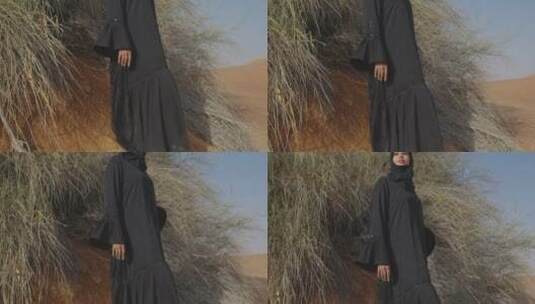 穆斯林女人穿着传统服装站在沙漠拍照高清在线视频素材下载