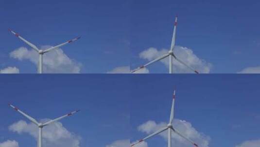 蓝天白云下运转的风力发电机高清在线视频素材下载