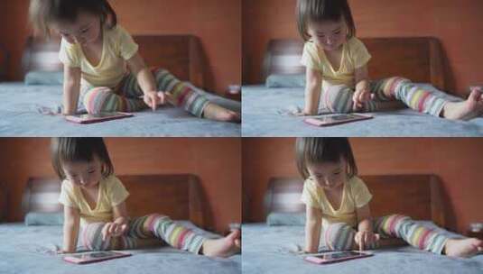 小女孩坐在床上玩手机高清在线视频素材下载