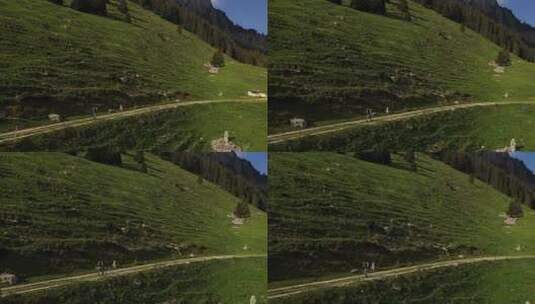 无人机拍摄，背包客夏季在山崖边的泥土小径上徒步旅行高清在线视频素材下载