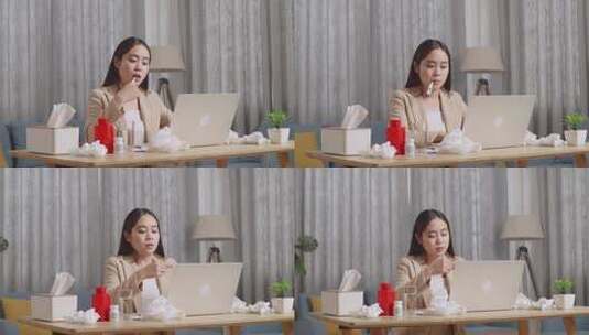 生病的亚洲女商人在使用笔记本电脑工作时使用温度计测试流感高清在线视频素材下载