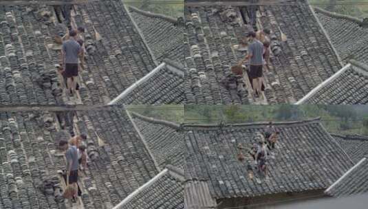 农民在屋顶捡瓦片维修瓦房高清在线视频素材下载