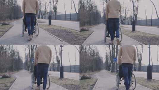 男人推着轮椅上的朋友散步高清在线视频素材下载