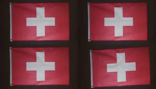 瑞士国旗在黑色背景下落下的工作室拍摄高清在线视频素材下载