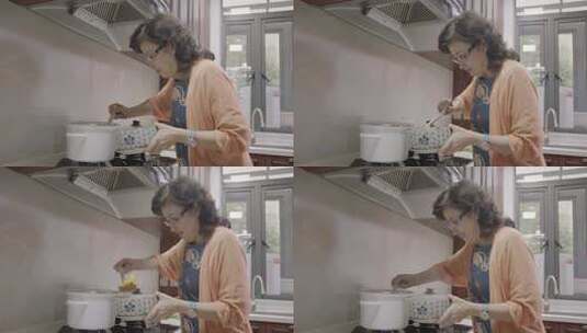 中年女子在厨房烹饪高清在线视频素材下载