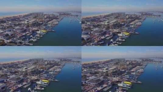 加利福尼亚州纽波特海滩巴尔博亚娱乐区和巴尔博亚岛渡轮的无人机天桥。高清在线视频素材下载