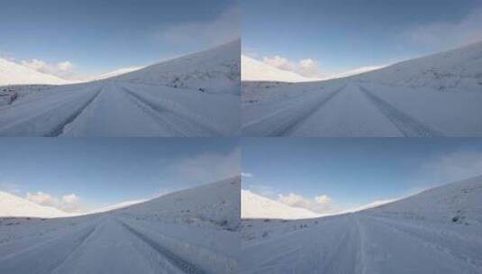 驾车穿过白雪覆盖的道路高清在线视频素材下载