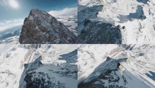 无人机飞跃雪山山顶俯冲下山视角高清在线视频素材下载