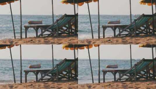 泰国芭堤雅沙滩上带伞的木制日光浴床高清在线视频素材下载