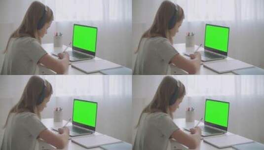 女孩用笔记电脑做家庭作业高清在线视频素材下载