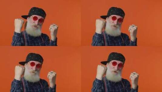 时尚的大胡子爷爷看着镜头做出庆祝成功的姿势高清在线视频素材下载