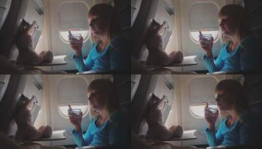 女孩在飞机上喝水高清在线视频素材下载