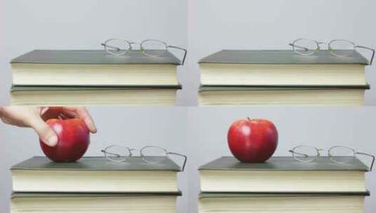 苹果和眼镜放在书本上高清在线视频素材下载