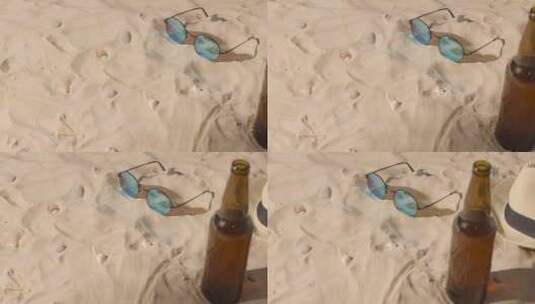 沙滩上啤酒瓶太阳镜特写高清在线视频素材下载