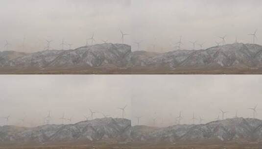雪山山顶转动的风力发电机高清在线视频素材下载
