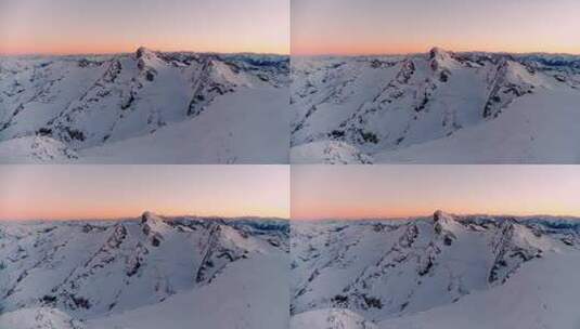 航拍阳光下的雪山日出巍峨山峰山脉山峦高清在线视频素材下载