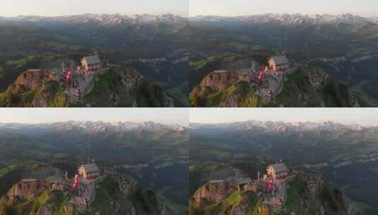 清晨无人驾驶飞机可以看到瑞士山顶，山上有餐厅和第一批客人。瑞士国旗高清在线视频素材下载