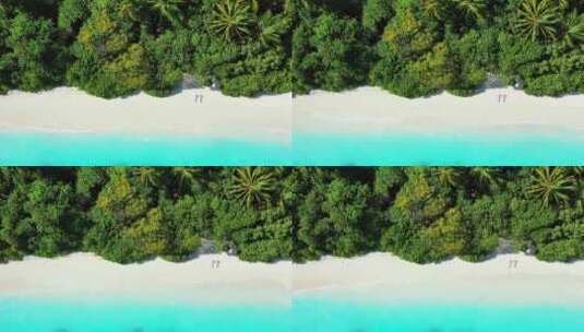 白色天堂海滩和水蓝色水背景的日间空中岛屿景观，色彩缤纷4K高清在线视频素材下载