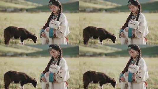 草原女子怀抱小羊的场景高清在线视频素材下载